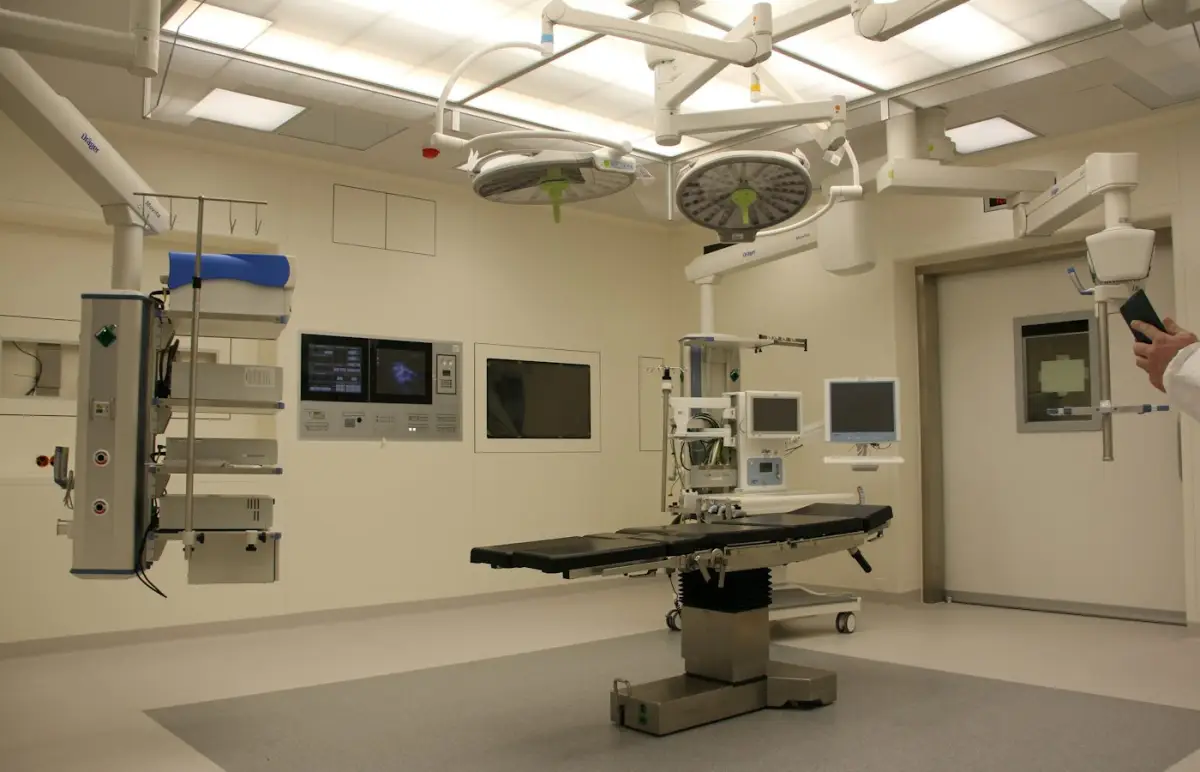 Modern operating theatre with surgical lights and monitors